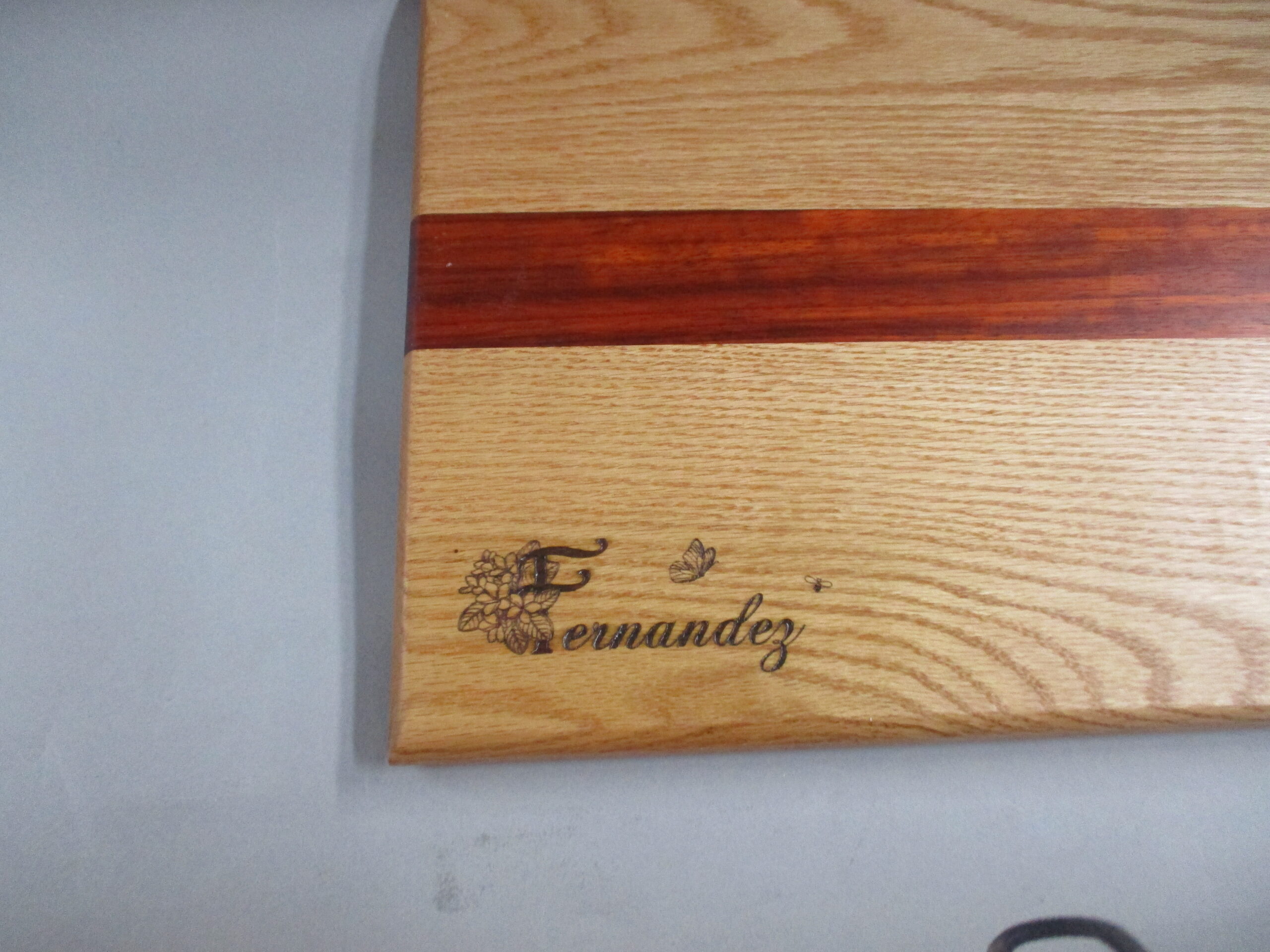 Custom engraved Oak and Padauk charcuterie board as a birthday gift.