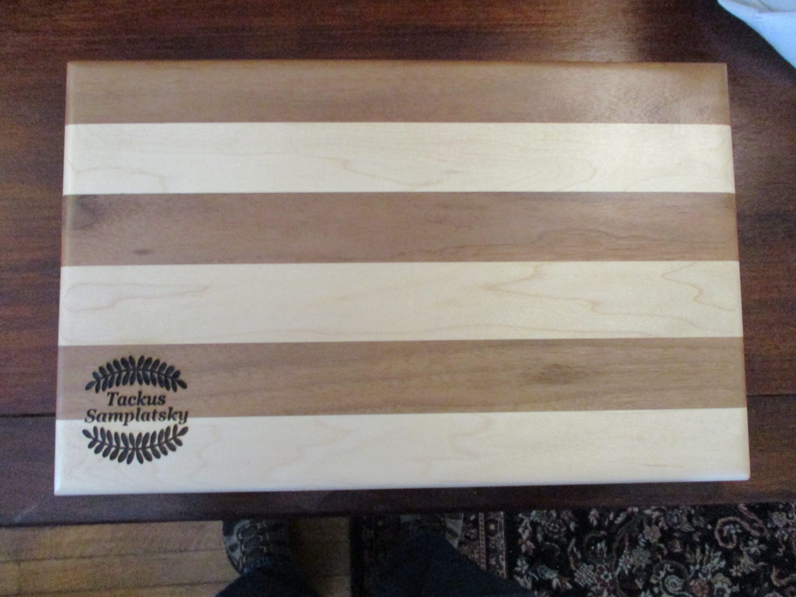 custom wreath engraved on Maple and Walnut cutting board/charcuterie board as a housewarming gift
