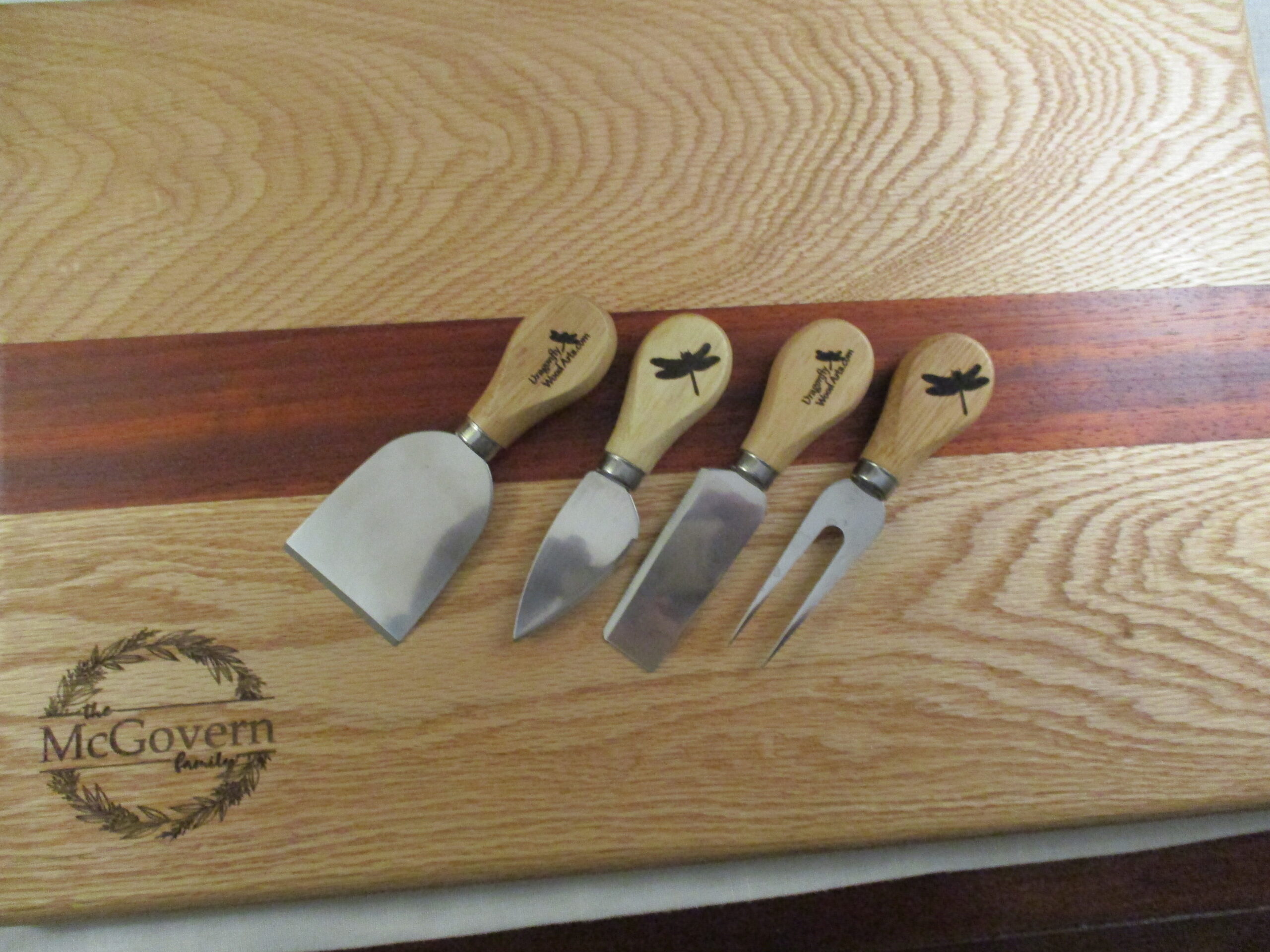 Custom Oak and Padauk cutting board/charcuterie board as a housewarming gift pictured with Charcuterie cutlery.