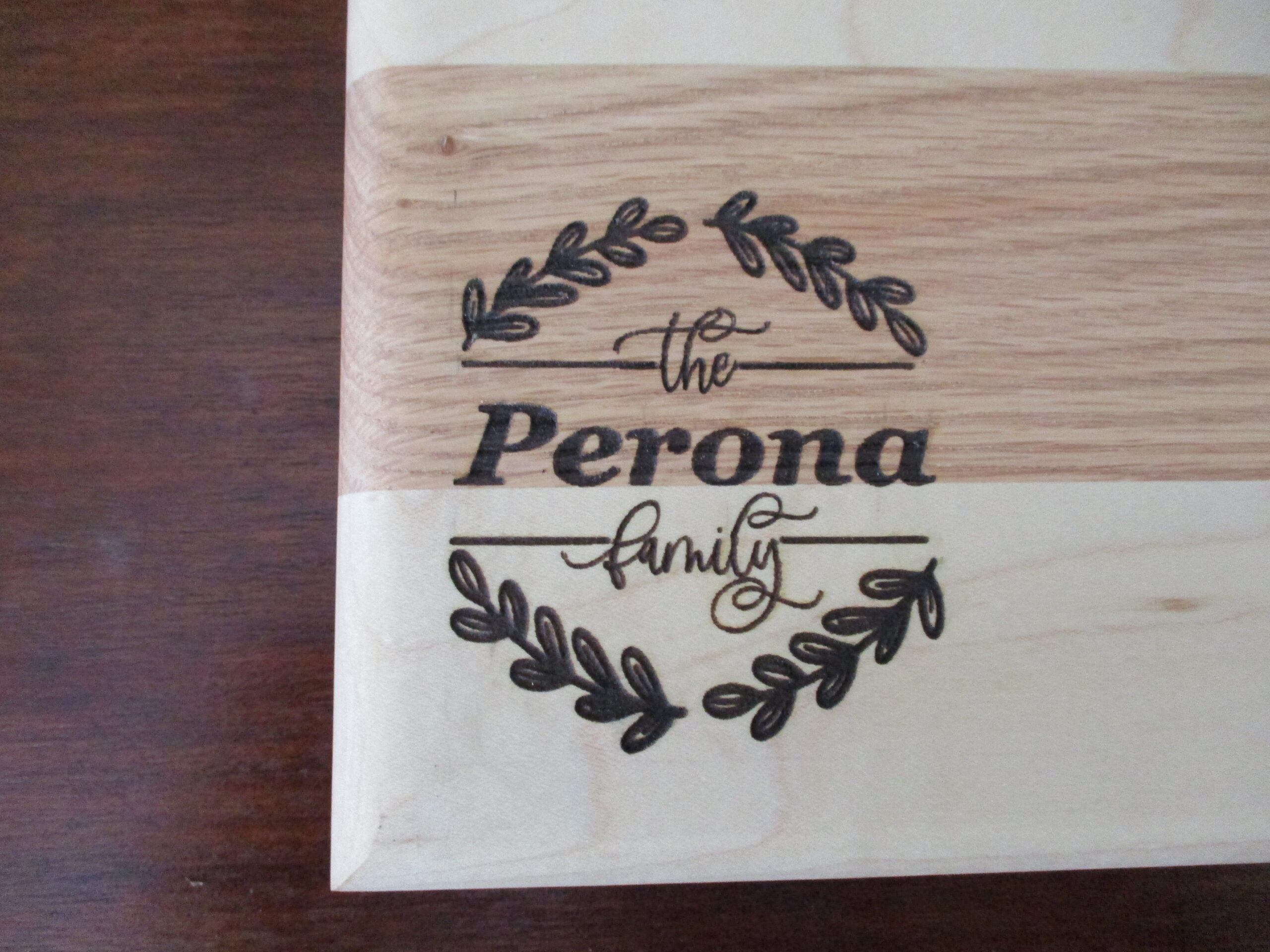 large view of Custom wreath engraved on Maple and Cherry cutting board/charcuterie board as a corporate gift.