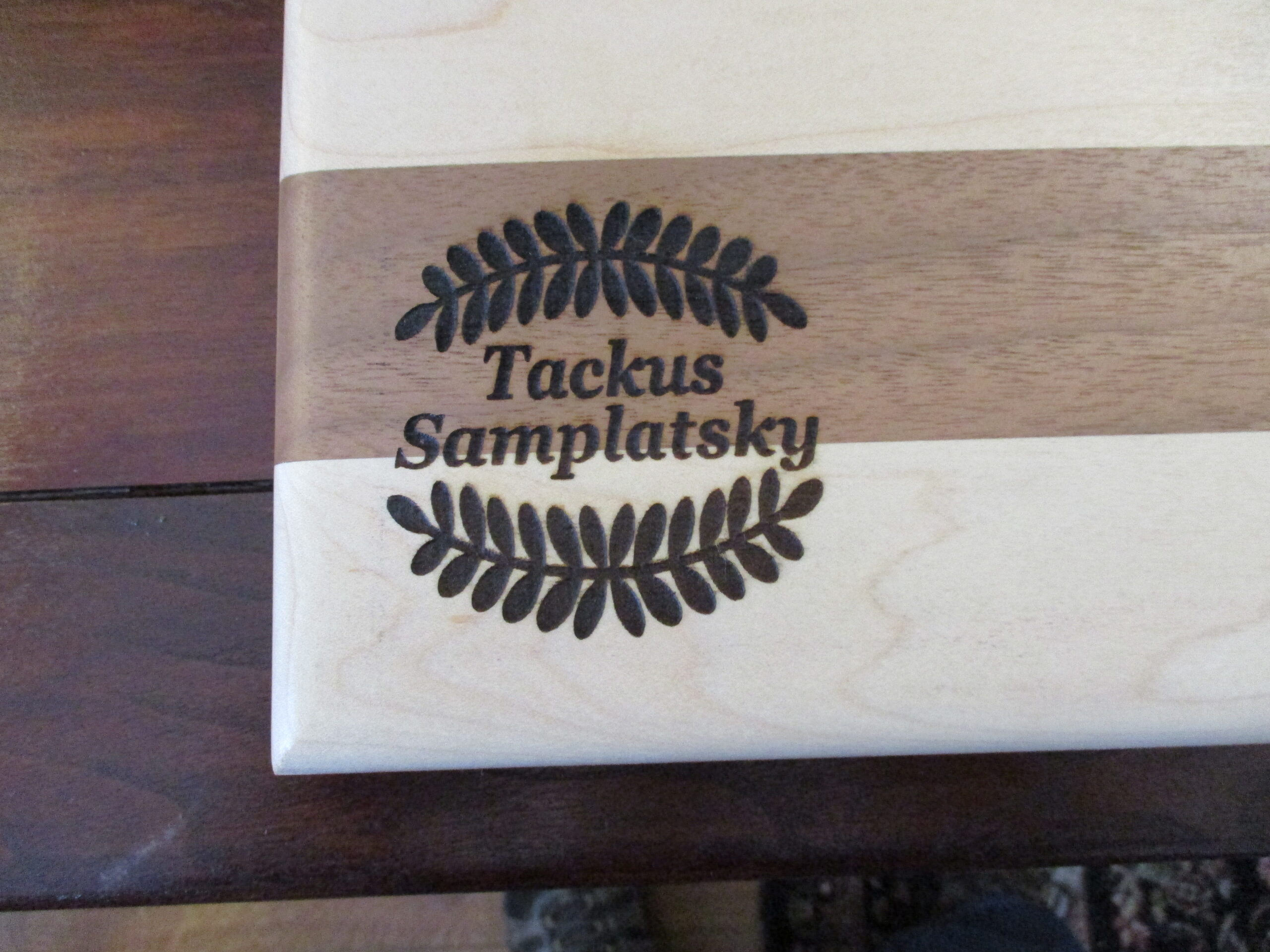 Custom wreath engraved on Maple and Walnut cutting board/charcuterie board as a corporate gift