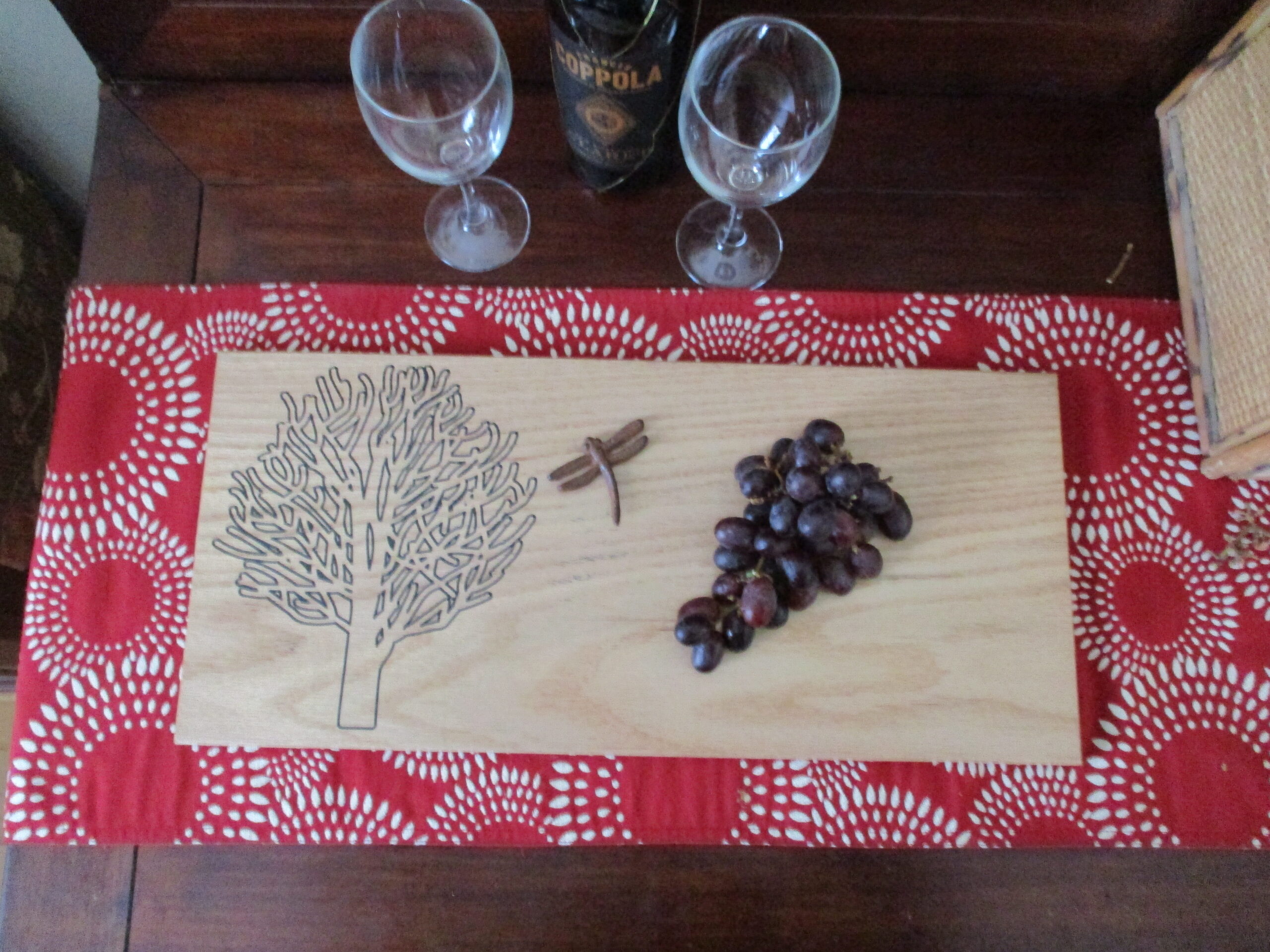 Custom Dry tree on oak charcuterie board with red grapes and dragonfly