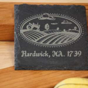 Customizable 4inch square slate coaster with a picture of a tractor plowing a field and the text hardwick ma 1739 dragonfly wood arts